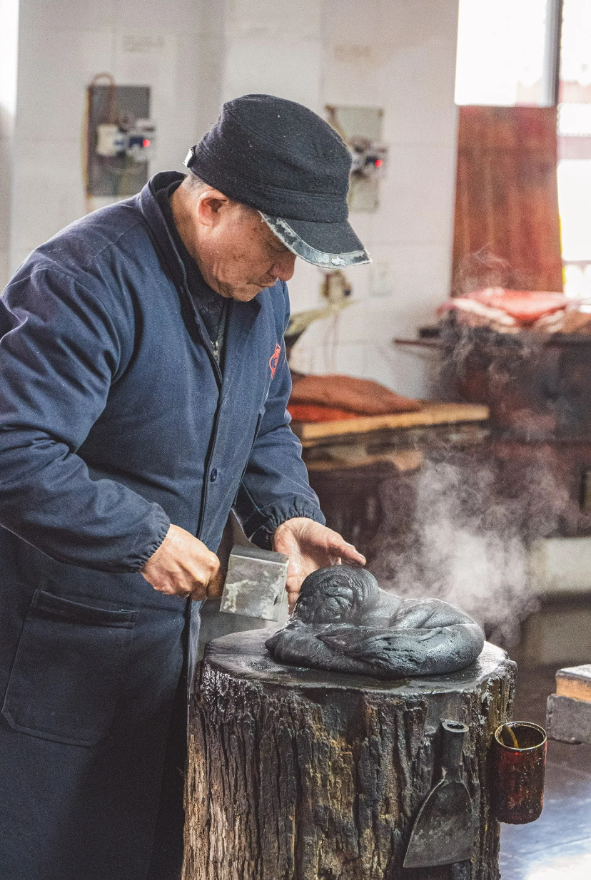 An artisan making ink the traditional way