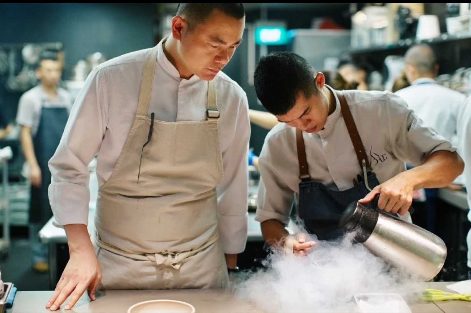 A chef plating at a fine-dining kitchen