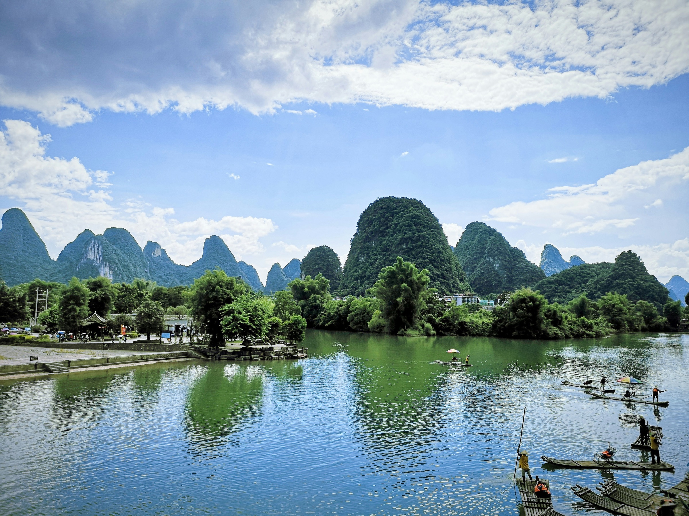 Karst peaks and bamboo rafts along a still river in Guilin